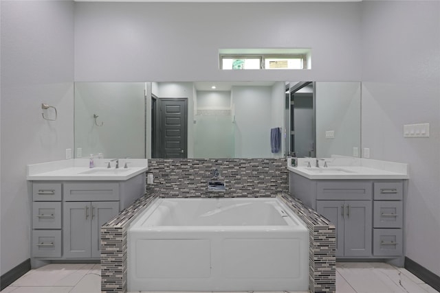 5215 Kelso St, Houston, TX 77021 - full bathroom with a bath, two vanities, and marble finish flooring