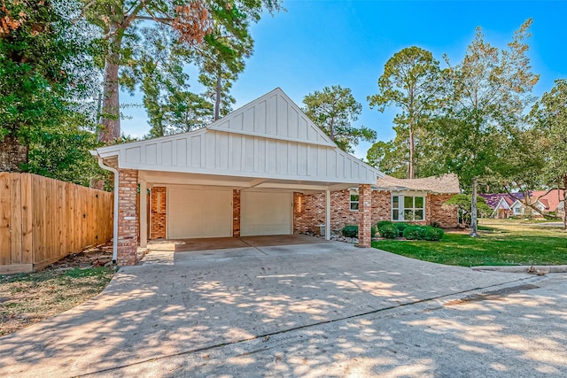 1714 Maux Dr, Houston, TX 77043 - view of front of home with board and batten siding, driveway, brick siding, and an attached garage