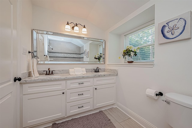 1714 Maux Dr, Houston, TX 77043 - bathroom featuring double vanity, tiled shower, and lofted ceiling