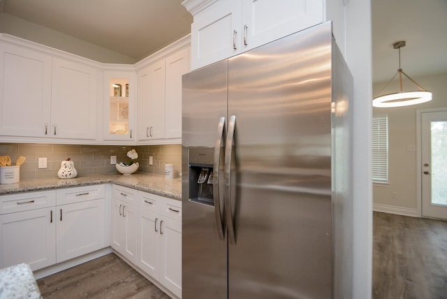 803 Cherokee Dr, Conroe, TX 77316 - kitchen with stainless steel refrigerator with ice dispenser, wood finished floors, white cabinets, tasteful backsplash, and glass insert cabinets