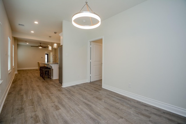 803 Cherokee Dr, Conroe, TX 77316 - unfurnished living room with wood finished floors, recessed lighting, and ceiling fan