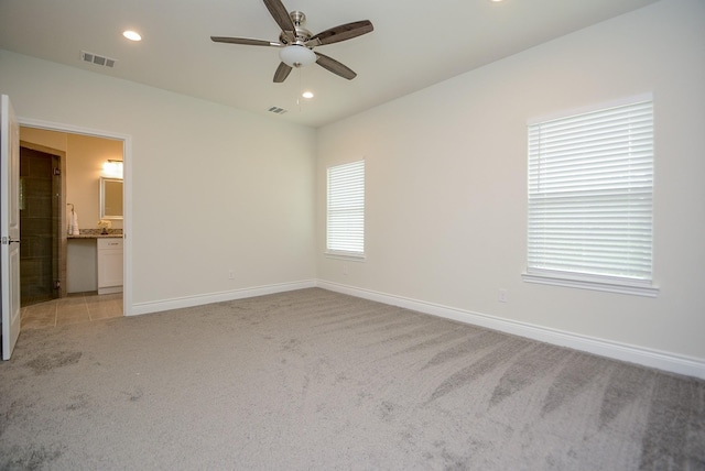 803 Cherokee Dr, Conroe, TX 77316 - empty room with light carpet, ceiling fan, and recessed lighting