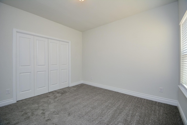 803 Cherokee Dr, Conroe, TX 77316 - unfurnished bedroom featuring carpet flooring and a closet