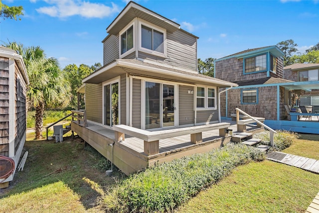 H6 The Bch Unit H6, Huntsville, TX 77320 - back of house featuring a wooden deck and a lawn