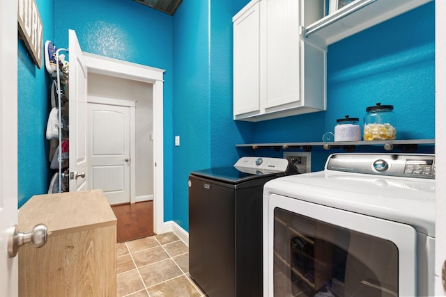 103 Jacks Corner Dr, Montgomery, TX 77316 - washroom featuring separate washer and dryer, cabinet space, light tile patterned floors, and a textured wall