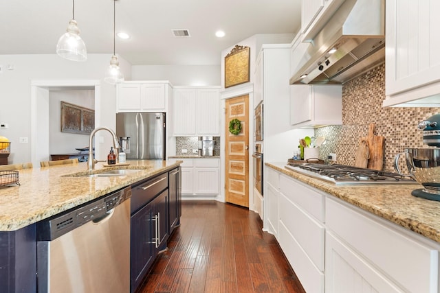 103 Jacks Corner Dr, Montgomery, TX 77316 - kitchen featuring stainless steel appliances, extractor fan, white cabinetry, pendant lighting, and light stone counters