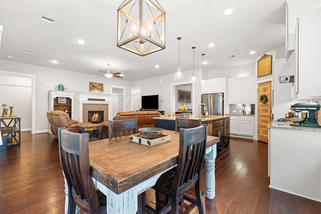 103 Jacks Corner Dr, Montgomery, TX 77316 - dining room featuring a fireplace, a ceiling fan, dark wood-style flooring, and recessed lighting