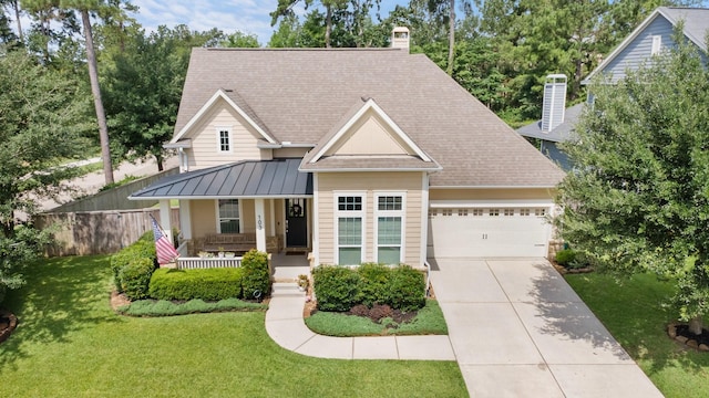 103 Jacks Corner Dr, Montgomery, TX 77316 - view of front facade with covered porch, an attached garage, driveway, a standing seam roof, and a chimney