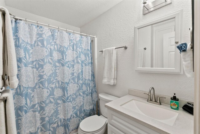 4630 Blue Water Hwy, Freeport, TX 77541 - full bath featuring vanity, a textured wall, a textured ceiling, and curtained shower