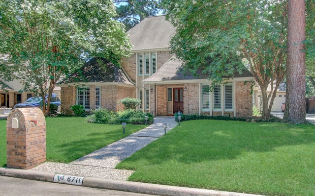 6711 Pebble Beach Dr, Houston, TX 77069 - view of front of house featuring brick siding, a front yard, and a shingled roof