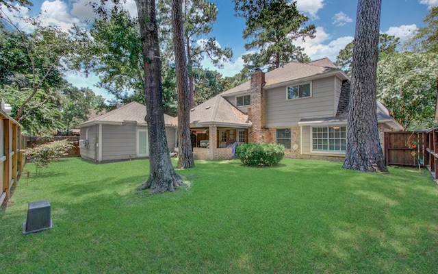 6711 Pebble Beach Dr, Houston, TX 77069 - back of property with a chimney, a fenced backyard, and brick siding