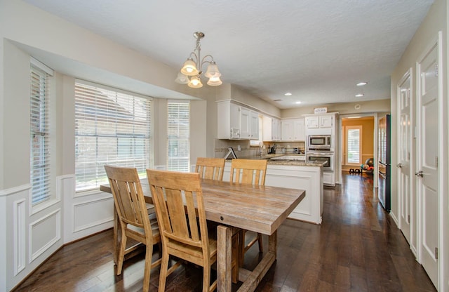 6711 Pebble Beach Dr, Houston, TX 77069 - dining space with dark wood-style floors, a chandelier, plenty of natural light, recessed lighting, and wainscoting
