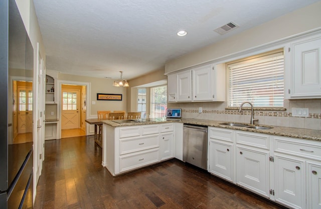 6711 Pebble Beach Dr, Houston, TX 77069 - kitchen with stainless steel dishwasher, a peninsula, white cabinetry, and recessed lighting