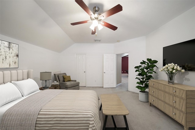 18 S April Mist Cir, The Woodlands, TX 77385 - bedroom with light colored carpet, vaulted ceiling, and a ceiling fan
