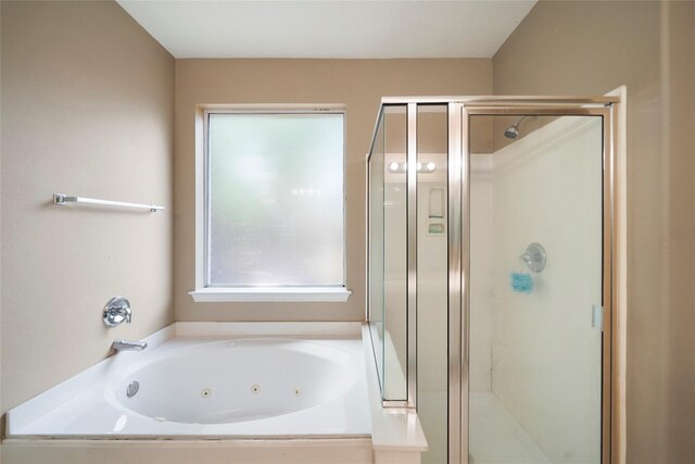 18 S April Mist Cir, The Woodlands, TX 77385 - bathroom featuring plenty of natural light, a stall shower, and a whirlpool tub