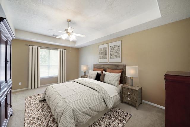 18 S April Mist Cir, The Woodlands, TX 77385 - bedroom with light colored carpet, a tray ceiling, ceiling fan, and a textured ceiling