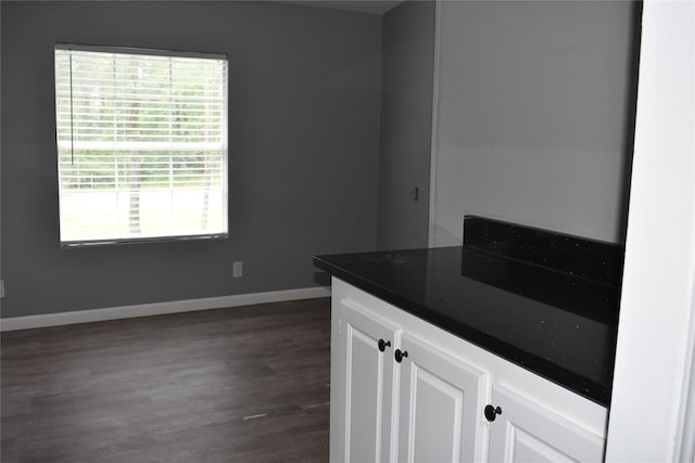 25 Wood Gln, Trinity, TX 75862 - kitchen with dark wood-style floors, dark countertops, and white cabinets