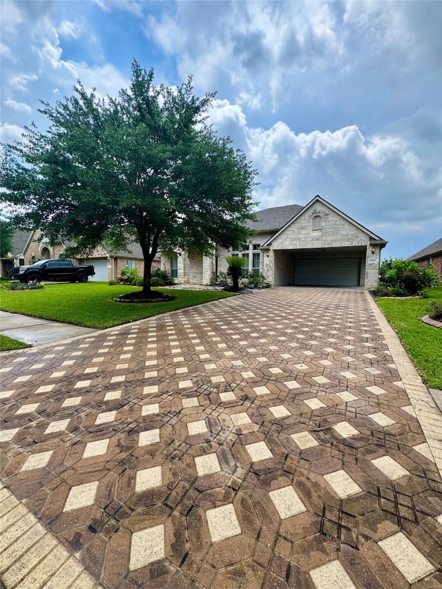 17907 Camp Cove Dr, Cypress, TX 77429 - ranch-style house featuring decorative driveway, a garage, a front lawn, and stone siding