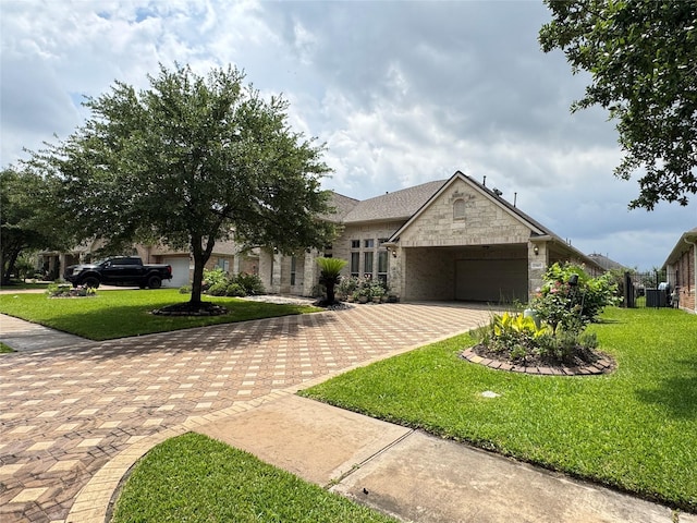17907 Camp Cove Dr, Cypress, TX 77429 - view of front facade with decorative driveway, stone siding, a garage, and a front lawn
