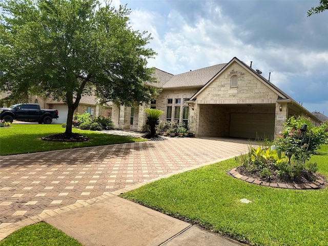 17907 Camp Cove Dr, Cypress, TX 77429 - view of front of house featuring decorative driveway, a garage, a front yard, brick siding, and stone siding