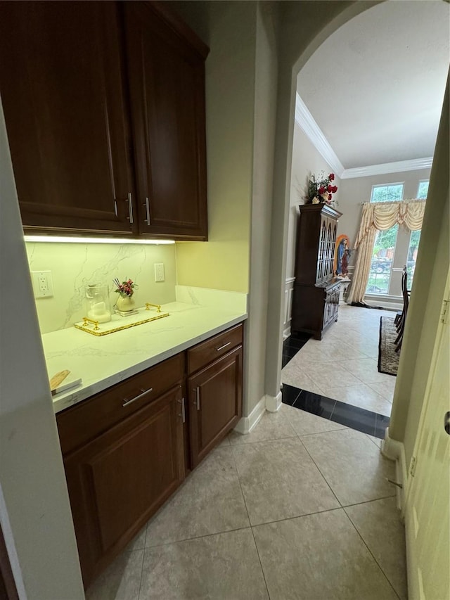 17907 Camp Cove Dr, Cypress, TX 77429 - bar with crown molding, arched walkways, and light tile patterned flooring