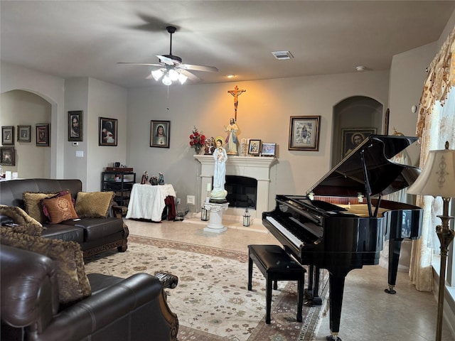 17907 Camp Cove Dr, Cypress, TX 77429 - living area featuring arched walkways, a ceiling fan, and a glass covered fireplace