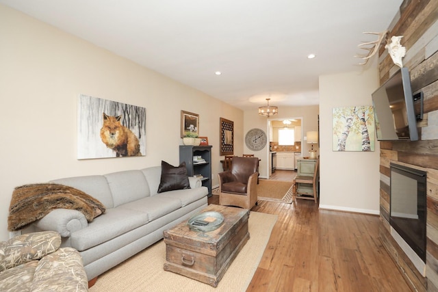 1015 Tri Oaks Ln Unit 23, Houston, TX 77043 - living room featuring hardwood / wood-style flooring, a chandelier, recessed lighting, and a fireplace