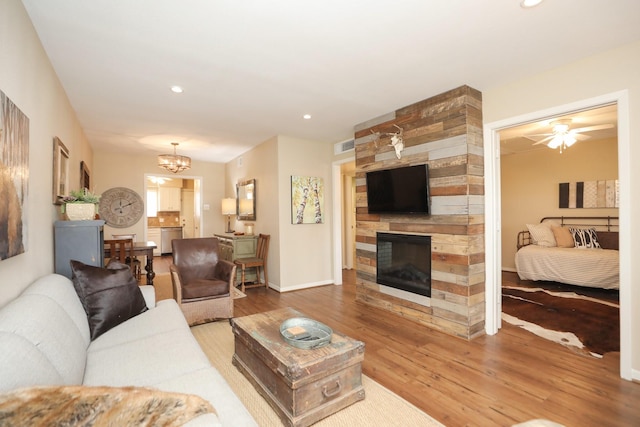 1015 Tri Oaks Ln Unit 23, Houston, TX 77043 - living room featuring wood-type flooring, a fireplace, a chandelier, recessed lighting, and ceiling fan
