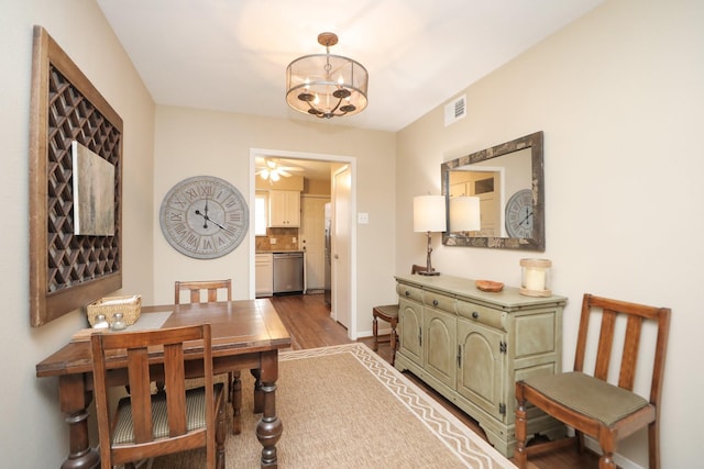 1015 Tri Oaks Ln Unit 23, Houston, TX 77043 - dining space with dark wood-style floors and a chandelier