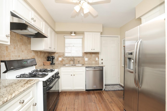 1015 Tri Oaks Ln Unit 23, Houston, TX 77043 - kitchen featuring appliances with stainless steel finishes, under cabinet range hood, a ceiling fan, white cabinets, and hardwood / wood-style floors