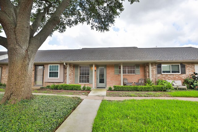 1015 Tri Oaks Ln Unit 23, Houston, TX 77043 - single story home with brick siding, a shingled roof, and a front yard