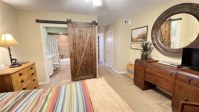 1015 Tri Oaks Ln Unit 23, Houston, TX 77043 - bedroom with a barn door, ensuite bathroom, and arched walkways