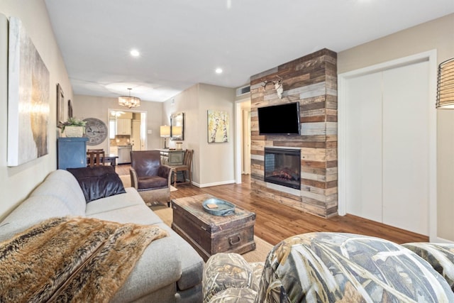 1015 Tri Oaks Ln Unit 23, Houston, TX 77043 - living room with wood finished floors, a fireplace, a chandelier, and recessed lighting