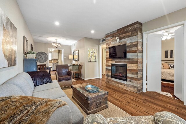 1015 Tri Oaks Ln Unit 23, Houston, TX 77043 - living area featuring a fireplace, hardwood / wood-style floors, recessed lighting, a ceiling fan, and a chandelier