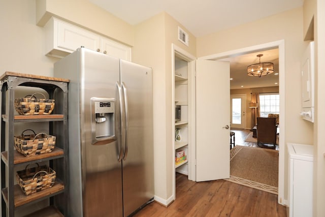 1015 Tri Oaks Ln Unit 23, Houston, TX 77043 - kitchen featuring stainless steel fridge, wood finished floors, white cabinetry, and a chandelier