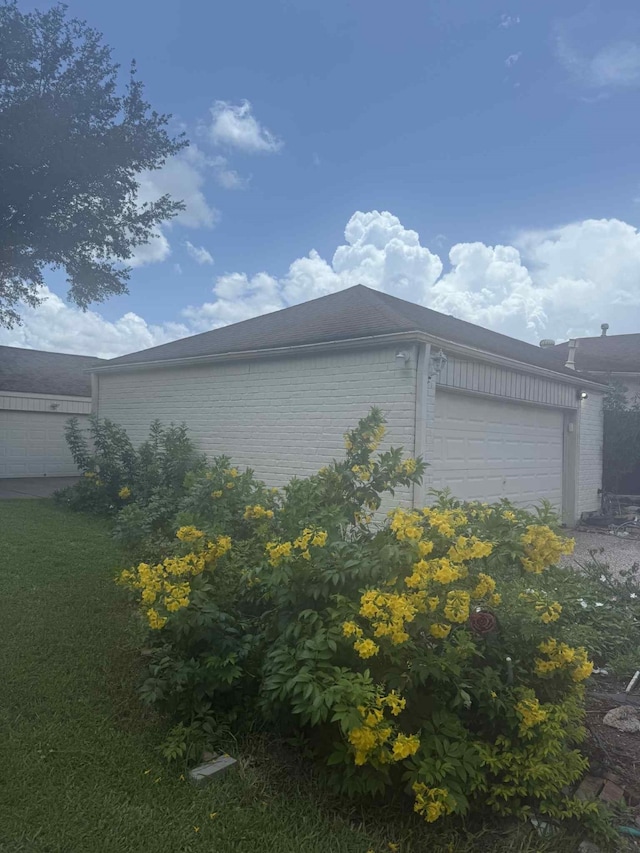 2302 Ashford Hollow Ln, Houston, TX 77077 - view of home's exterior featuring brick siding and an attached garage