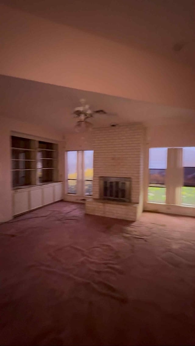 2302 Ashford Hollow Ln, Houston, TX 77077 - unfurnished living room with a brick fireplace, plenty of natural light, and built in features