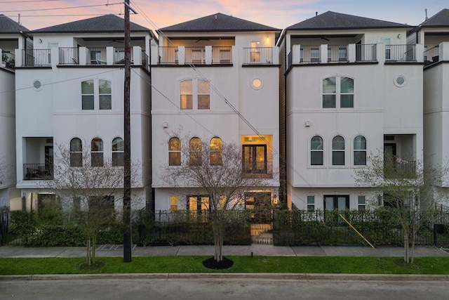 1829 W Main St Unit C, Houston, TX 77098 - property at dusk with a fenced front yard