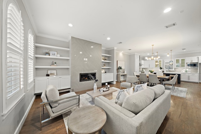 1829 W Main St Unit C, Houston, TX 77098 - living area with ornamental molding, recessed lighting, dark wood-style floors, a premium fireplace, and a chandelier