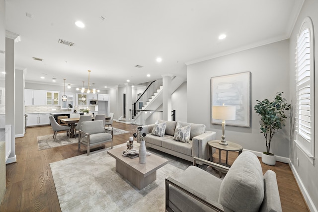 1829 W Main St Unit C, Houston, TX 77098 - living area featuring recessed lighting, light wood-style flooring, crown molding, stairway, and a chandelier