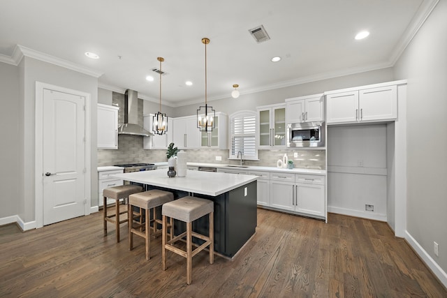 1829 W Main St Unit C, Houston, TX 77098 - kitchen featuring wall chimney range hood, white cabinets, a chandelier, decorative backsplash, and glass insert cabinets