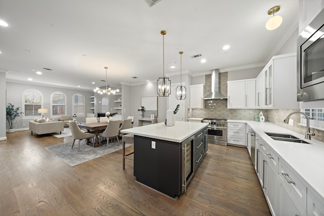 1829 W Main St Unit C, Houston, TX 77098 - kitchen with wall chimney exhaust hood, appliances with stainless steel finishes, tasteful backsplash, crown molding, and white cabinetry