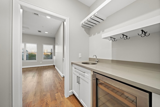 1829 W Main St Unit C, Houston, TX 77098 - indoor wet bar featuring beverage cooler, light wood-style flooring, and recessed lighting