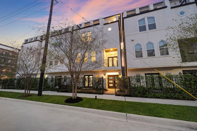 1829 W Main St Unit C, Houston, TX 77098 - view of property featuring a fenced front yard, stucco siding, and a gate