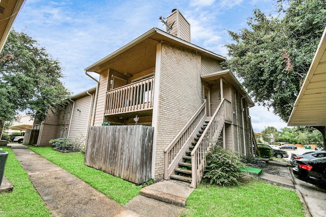 1505 Ward Rd Unit 182, Baytown, TX 77520 - view of home's exterior with a chimney and stairs