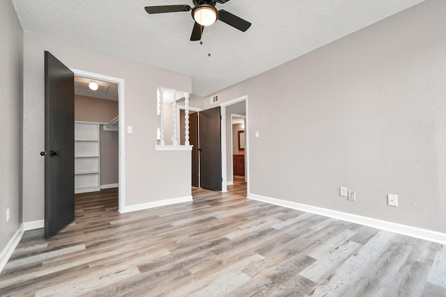 1505 Ward Rd Unit 182, Baytown, TX 77520 - unfurnished bedroom with light wood-type flooring, a textured ceiling, a walk in closet, and a closet