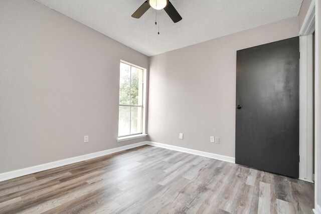 1505 Ward Rd Unit 182, Baytown, TX 77520 - empty room with light wood-type flooring, ceiling fan, and a textured ceiling