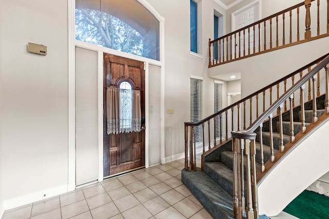 3318 Teawick Ct, Houston, TX 77068 - tiled foyer featuring stairway, a towering ceiling, and crown molding