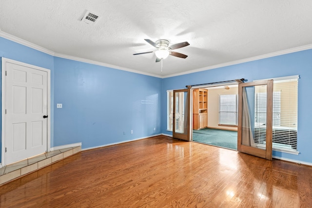 3318 Teawick Ct, Houston, TX 77068 - empty room featuring a ceiling fan, wood finished floors, ornamental molding, and a textured ceiling