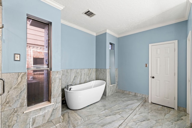 3318 Teawick Ct, Houston, TX 77068 - bathroom with marble tiled flooring, a soaking tub, tile walls, wainscoting, and ornamental molding